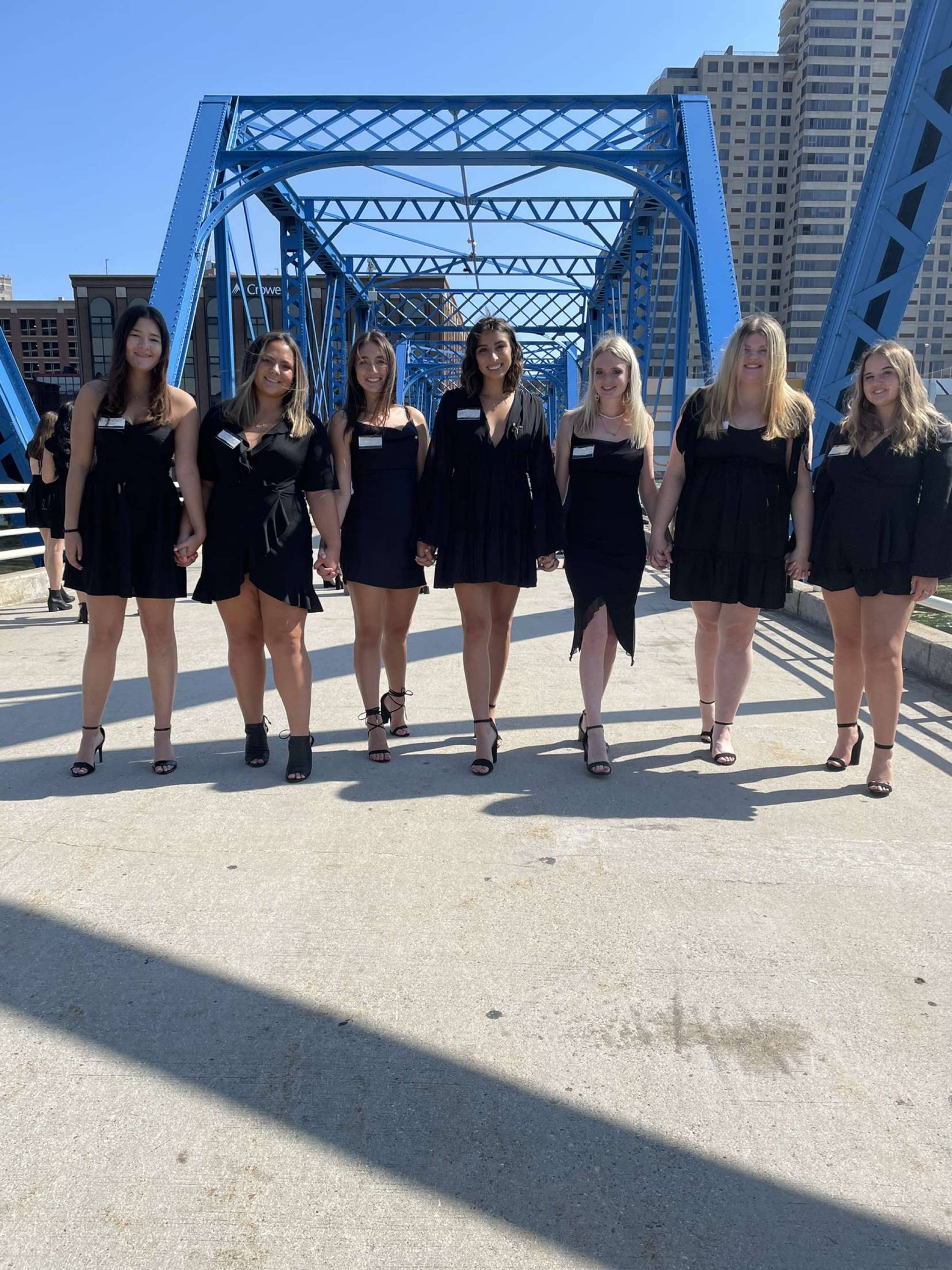 Alpha Sigma Alpha sisters walking the Blue Bridge downtown Grand Rapids, hand in hand.